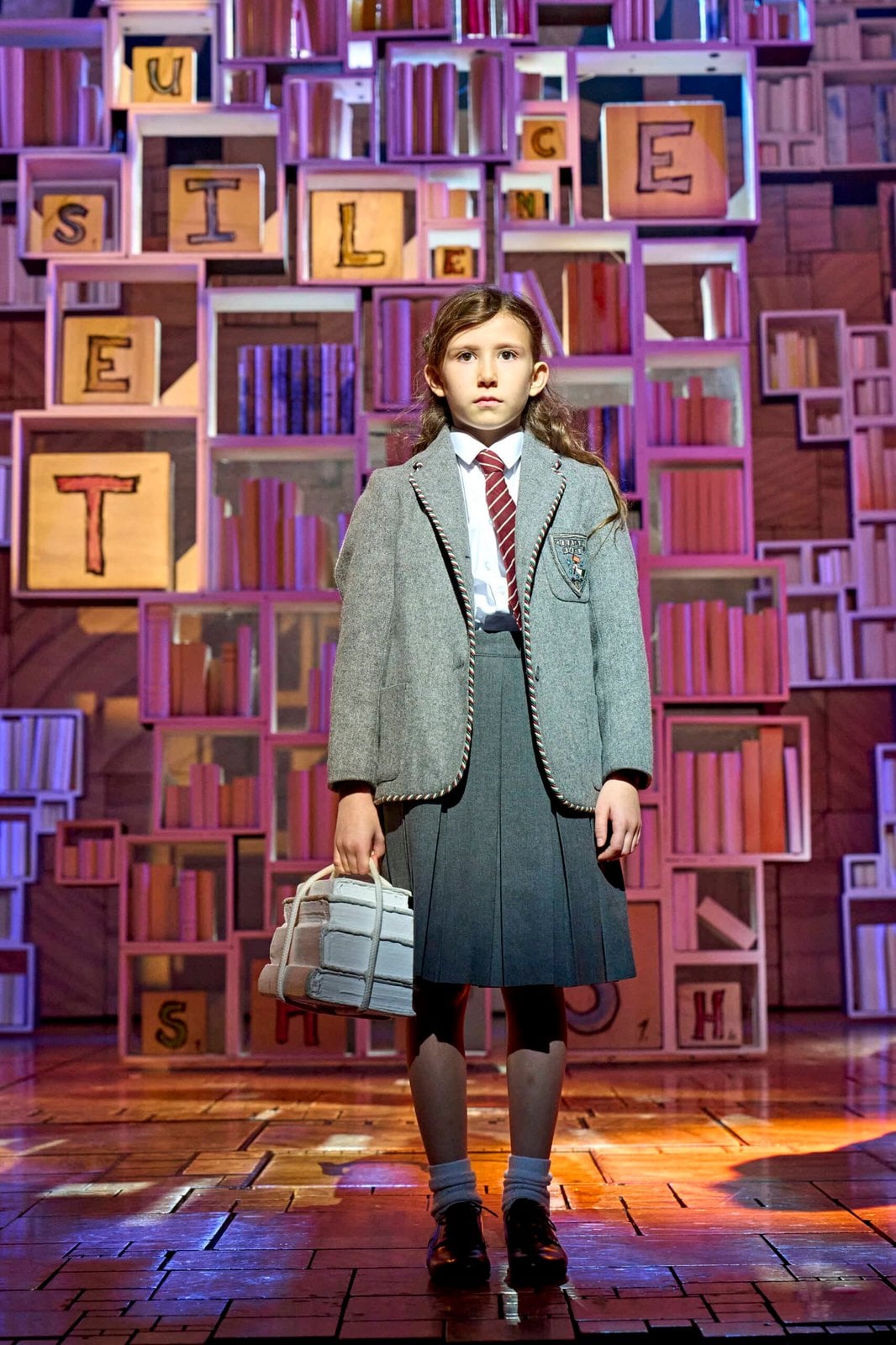 A performer in a Matilda production scene