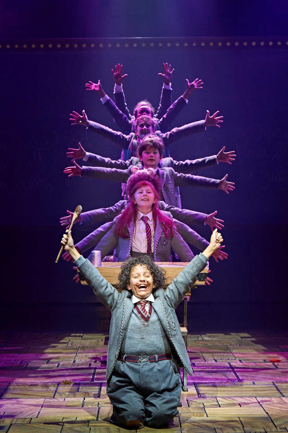 Performers in a Matilda stage scene