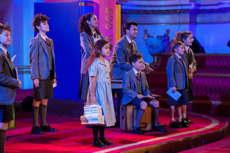Matilda performers together in a production scene