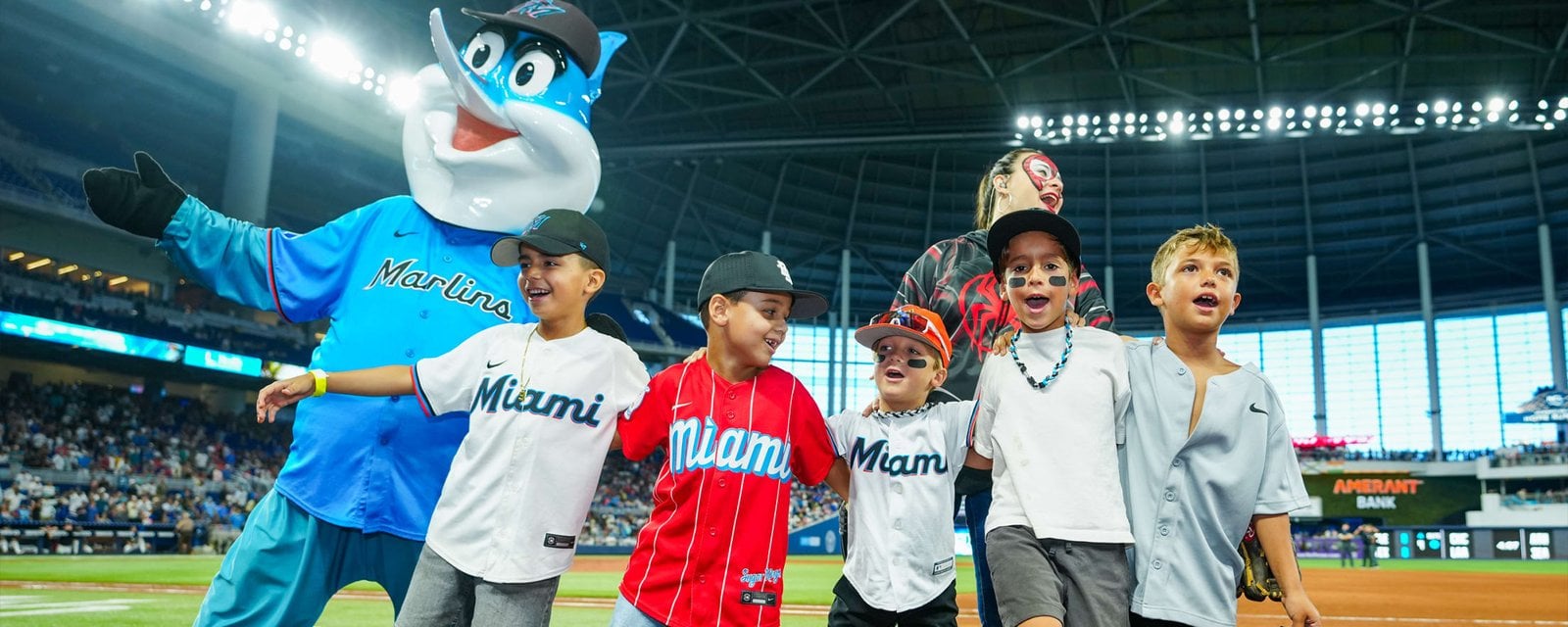 Miami Marlins mascot with children inside the ballpark