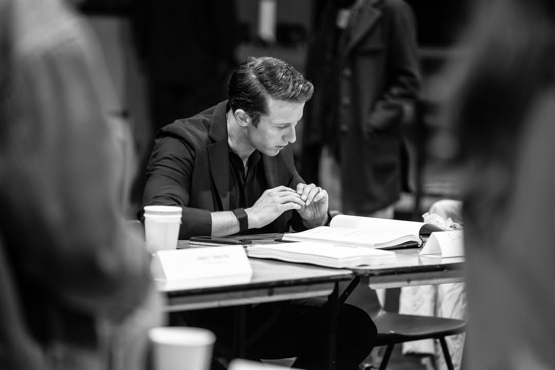 An actor studies a script during a Sinatra the Musical rehearsal