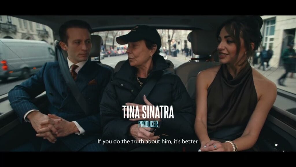 Tina Sinatra speaks with two people in a car during a filmed conversation