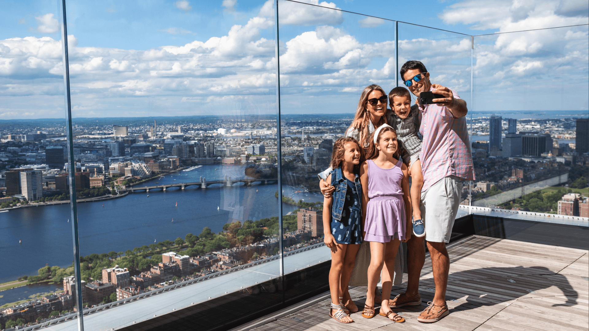Family taking in Boston from a high observation point