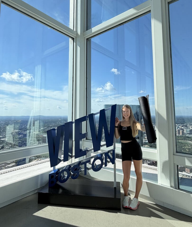 Visitor enjoying a rooftop view over Boston